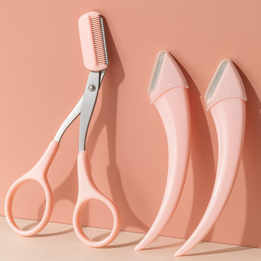 Blush pink face razors and safety brow scissors on peach background.
